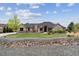 Charming single-story home featuring stone accents, manicured lawn, and lovely landscaping at 12939 Wabash Ct, Thornton, CO 80602