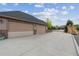 Spacious three-car garage with ample parking and driveway space; potential for car enthusiasts or extra storage at 12939 Wabash Ct, Thornton, CO 80602