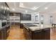 Gourmet kitchen with stainless steel appliances, granite countertops, a spacious island, and dark wood cabinetry at 12939 Wabash Ct, Thornton, CO 80602