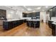 Large kitchen features stainless steel appliances, dark wood cabinets, and granite countertops with a center island at 12939 Wabash Ct, Thornton, CO 80602