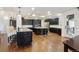 Open kitchen features dark wood cabinets, granite countertops, stainless steel appliances, and island with seating at 12939 Wabash Ct, Thornton, CO 80602