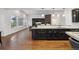 Open kitchen features dark cabinets, stainless appliances, large island, and seamless flow into the living area at 12939 Wabash Ct, Thornton, CO 80602