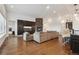 Open-concept living space with stone fireplace, hardwood floors, and modern design at 12939 Wabash Ct, Thornton, CO 80602