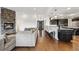 Open-concept living space with stone fireplace, hardwood floors, and modern design at 12939 Wabash Ct, Thornton, CO 80602