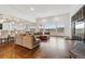 Spacious living room with hardwood floors, large windows, and open floor plan at 12939 Wabash Ct, Thornton, CO 80602