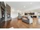 Open-concept living space with stone fireplace, hardwood floors, and modern design at 12939 Wabash Ct, Thornton, CO 80602