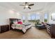 Spacious primary bedroom with large windows offering scenic views, tray ceilings, and ample natural light at 12939 Wabash Ct, Thornton, CO 80602