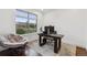 Bright office features large window with neighborhood views, modern desk and comfortable papasan chair at 12939 Wabash Ct, Thornton, CO 80602