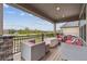 Relaxing covered patio with stylish outdoor furniture, string lights, and scenic views of the community at 12939 Wabash Ct, Thornton, CO 80602