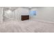 Spacious carpeted basement with natural light and a stylish wood dresser, ready for customization at 2419 Flats St, Erie, CO 80516