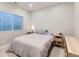 Cozy bedroom with natural light from a window, complete with simple furnishings at 2419 Flats St, Erie, CO 80516