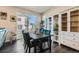 Cozy dining area with hardwood floors, a large window, and stylish decor at 2419 Flats St, Erie, CO 80516