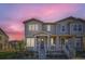 Charming two-story townhome with a covered front porch and beautiful landscaping at 2419 Flats St, Erie, CO 80516