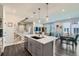 Open-concept kitchen with granite countertops, stainless steel appliances, and stylish pendant lighting at 2419 Flats St, Erie, CO 80516