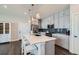 Modern kitchen featuring a central island, white countertops, and stainless steel appliances at 2419 Flats St, Erie, CO 80516