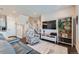 Comfortable living room featuring a staircase, a large TV, and stylish furnishings at 2419 Flats St, Erie, CO 80516