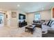Spacious living room with comfortable seating, a large TV, and a neutral color palette at 2419 Flats St, Erie, CO 80516