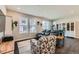 Inviting living room featuring large windows, hardwood floors, and comfortable seating at 2419 Flats St, Erie, CO 80516