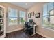 Bright office space with multiple windows, hardwood floors, and a functional workstation at 2419 Flats St, Erie, CO 80516