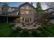 The backyard features a stone patio with an outdoor seating area, fire pit, and a lush grassy lawn at 5320 S Geneva St, Englewood, CO 80111