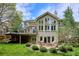 Gorgeous backyard with stone patio, fire pit, lush landscaping, and a spacious deck at 5320 S Geneva St, Englewood, CO 80111