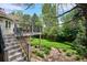 Backyard featuring a stone patio, lush lawn, and stone steps leading to a deck at 5320 S Geneva St, Englewood, CO 80111