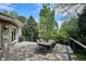 Outdoor backyard deck with a table and seating surrounded by beautiful mature trees at 5320 S Geneva St, Englewood, CO 80111