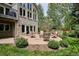 A beautiful backyard features a stone patio, a cozy fire pit, and mature landscaping at 5320 S Geneva St, Englewood, CO 80111