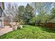 A spacious backyard featuring a stone patio with an outdoor seating area and a fire pit at 5320 S Geneva St, Englewood, CO 80111
