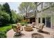Serene backyard with a stone patio, fire pit, and lush green lawn at 5320 S Geneva St, Englewood, CO 80111