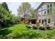 Spacious backyard with a stone patio, fire pit, and lush green lawn at 5320 S Geneva St, Englewood, CO 80111