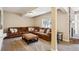 Finished basement area with carpeting, a large sectional sofa and a small fireplace at 5320 S Geneva St, Englewood, CO 80111