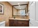 Elegant half-bath with granite counters, decorative mirror, and stylish fixtures at 5320 S Geneva St, Englewood, CO 80111