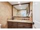 Elegant bathroom with granite countertop, decorative mirror, and fixtures at 5320 S Geneva St, Englewood, CO 80111