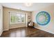 Bright bedroom featuring hardwood floors, natural light and large colorful wall decor at 5320 S Geneva St, Englewood, CO 80111