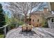 Spacious outdoor deck with metal railing and dining table with chairs under a mature tree at 5320 S Geneva St, Englewood, CO 80111