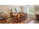Elegant dining room boasts hardwood floors, natural lighting, and classic furniture at 5320 S Geneva St, Englewood, CO 80111