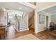 Bright foyer features hardwood floors, staircase, and entry to the living area at 5320 S Geneva St, Englewood, CO 80111