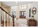 Elegant foyer with hardwood floors, wooden door, and high ceilings with clerestory windows at 5320 S Geneva St, Englewood, CO 80111