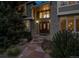 A welcoming home exterior showcasing a brick facade, a decorative front door and manicured shrubs and trees at 5320 S Geneva St, Englewood, CO 80111