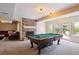 Basement game room with a pool table, fireplace, and access to an outdoor patio space at 5320 S Geneva St, Englewood, CO 80111