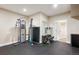 Finished basement workout room with gym equipment, rubber flooring, and ample open space at 5320 S Geneva St, Englewood, CO 80111