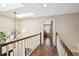Bright hallway with hardwood floors, a skylight, and an elegant chandelier, creating an inviting space at 5320 S Geneva St, Englewood, CO 80111