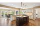 Spacious kitchen featuring a central island, granite countertops, and modern lighting at 5320 S Geneva St, Englewood, CO 80111