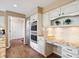 Gourmet kitchen featuring white cabinets, granite countertops, and stainless steel appliances at 5320 S Geneva St, Englewood, CO 80111