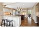 Open concept kitchen with a breakfast bar, modern appliances, and a view to the dining area at 5320 S Geneva St, Englewood, CO 80111