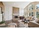 Bright living room with large windows, fireplace, and neutral-toned furniture, creating a welcoming atmosphere at 5320 S Geneva St, Englewood, CO 80111