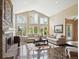 Spacious living room featuring a fireplace, large windows, and comfortable seating, perfect for relaxation at 5320 S Geneva St, Englewood, CO 80111