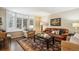Cozy living room featuring a bay window, leather sofa, and neutral decor at 5320 S Geneva St, Englewood, CO 80111