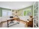 Cozy office space with built-in shelves, desk, and comfortable seating, ideal for working from home at 5320 S Geneva St, Englewood, CO 80111